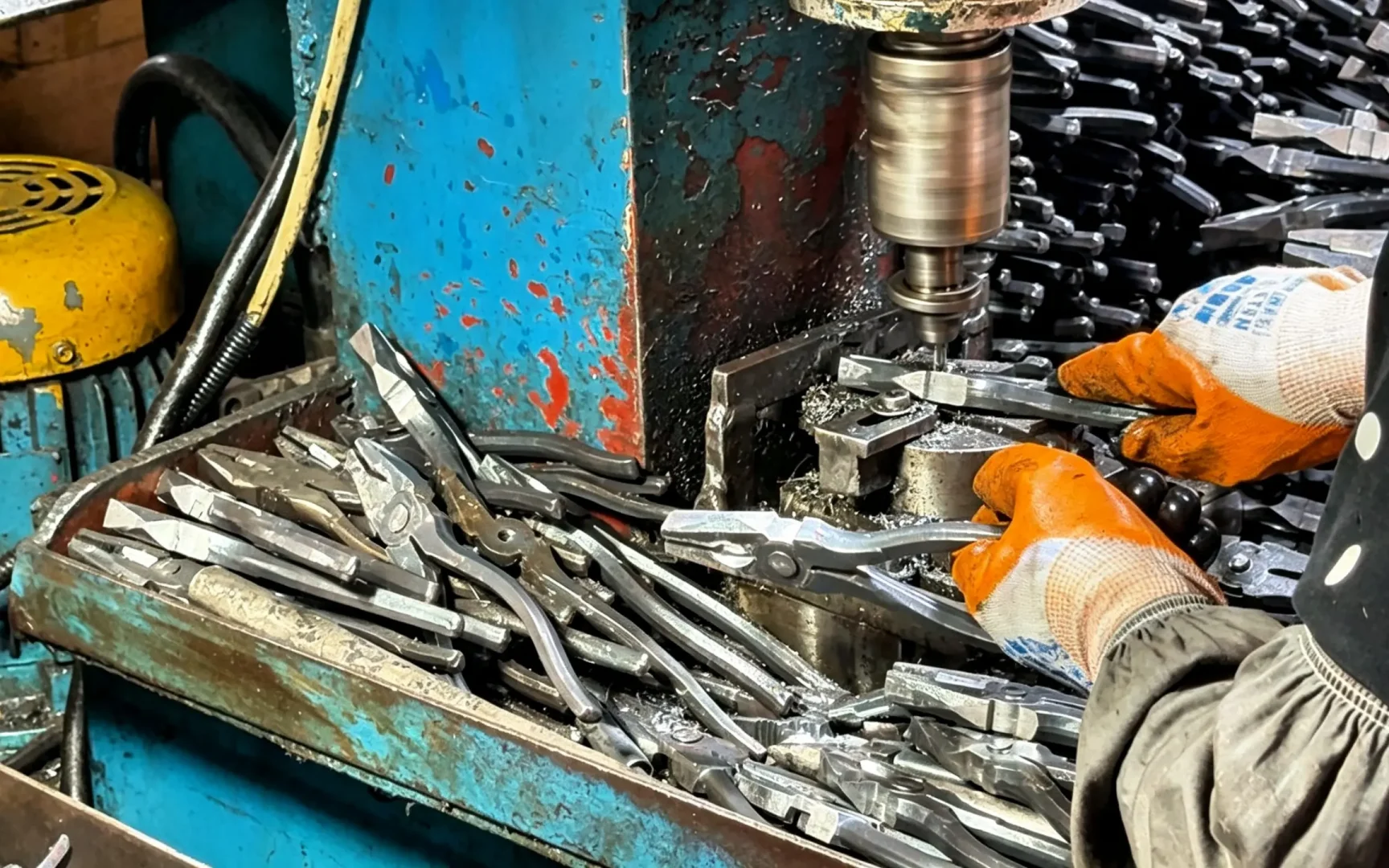 Worker drilling rivet holes for CR‑V combination pliers, Huashutools www.huashutools.com